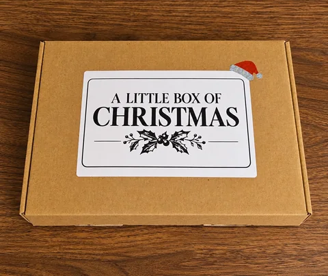 Closed kraft gift box labelled A Little Box of Christmas