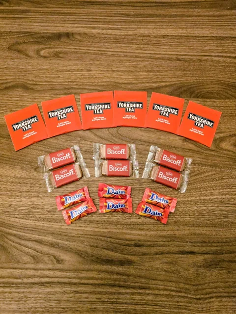 Yorkshire Tea, chocolate and biscuits arranged on a wooden table